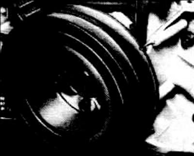 Use a strobe light to illuminate the ignition timing marks on the belt pulley.