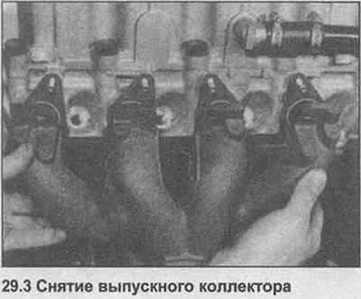 3. Gradually loosen the nuts, then remove the exhaust manifold from the struts on the cylinder head…