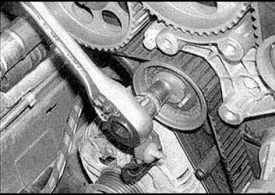6. Install the camshaft sprocket locking tool (drawing on the left). The TOR marks should be facing…