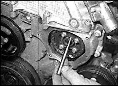 7. Check that the crankshaft pulley mark is aligned with the pointer and insert the crankshaft lock…