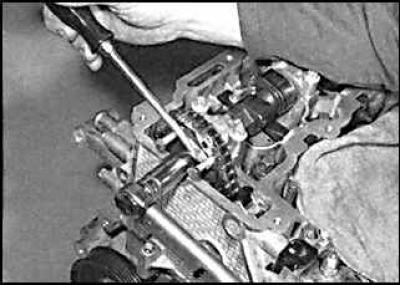 17. After installing all the locking pins, seat the camshaft sprocket in place by tightening the…
