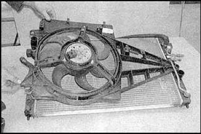 7. Remove the three screws securing the fan shroud to the rear of the radiator.