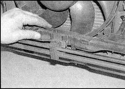 4. Remove the cover and disconnect the auxiliary fan wiring harness from the multi-pin connector.