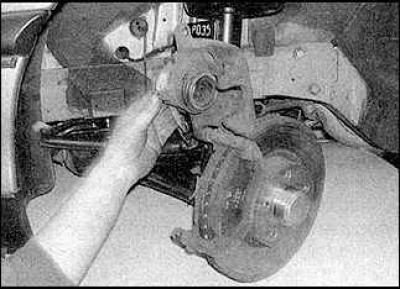 9. Unscrew and remove the lower caliper pin bolt.