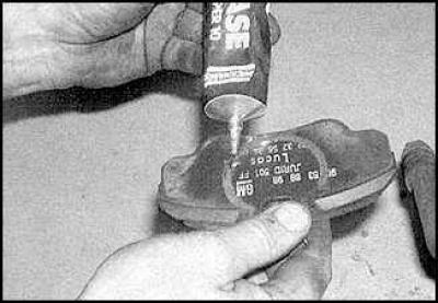 2. Lower the piston into the caliper using a clamp.