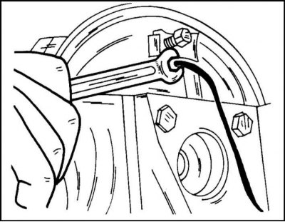 6. Loosen the union nut of the brake line from the back of the brake shield and disconnect the line.