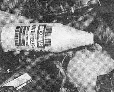 Photo 2.1B. Adding coolant to the expansion tank.