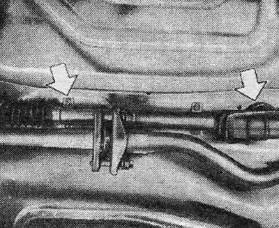 Figure 6.7. Protective cover and gear shift rod cover (shown by arrows)