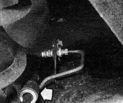 Photo 27.4 Short handbrake cable and rings (indicated by arrows)