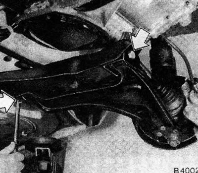 Figure 10.6. Unscrew the control bracket bolts - indicated by arrows