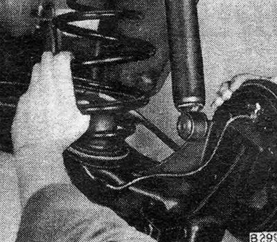 Рис. 10.22 — Снятие задней спиральной пружины