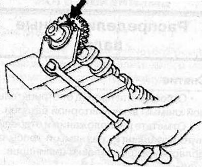 Screw the M5x0.8 screws (arrow) into the camshaft gears, so that both sections of the gear are…