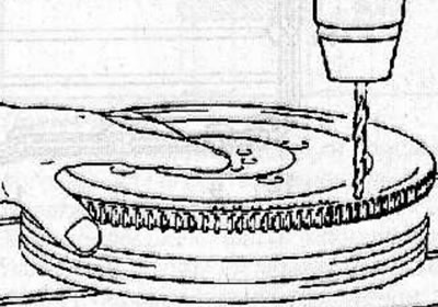 Use a tap to clean the threaded holes in the crankshaft for the flywheel mounting bolts.