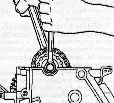 Remove the camshaft sprocket mounting bolt, holding the shaft by the hexagon with a wrench to…