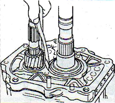 Remove the main shaft retaining ring from the groove in the intermediate plate.