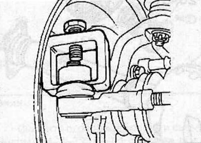 Loosen the nut securing the ball joint pin of the steering rod end to the steering knuckle. Using…
