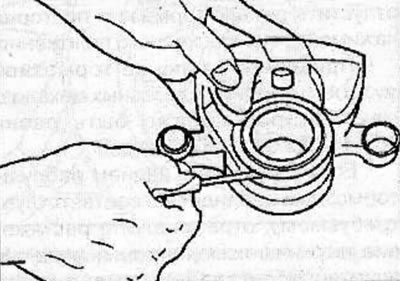 Use a small screwdriver to remove the dust seal ring.