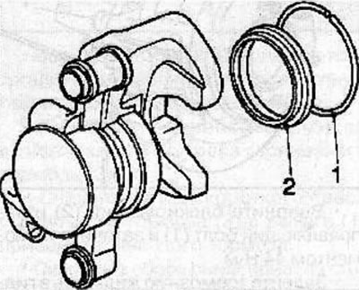 Instalați garnitura (2) și inelul (1) pe piston.