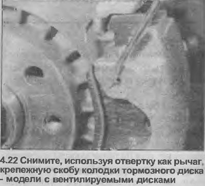 22. Using a screwdriver as a lever, remove the brake pad retaining clip from the outer edge of the…