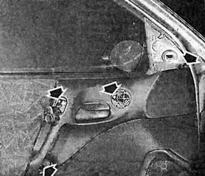 The arrows show all the mounting bolts that secure the interior handle to the door metal.