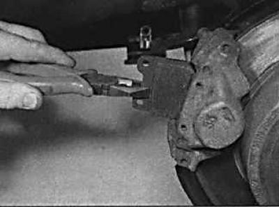 4. Using a special tool or pliers, remove the outer brake pad from the caliper.