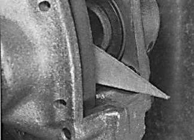 9. If new brake pads are to be installed, press the piston into the caliper with the handle of a…