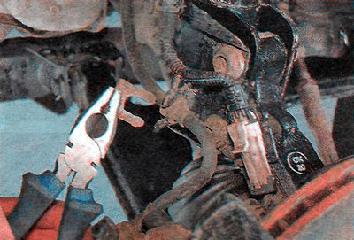 6. Пасатыжамі здымаем стопорную дужку і здабываем з кранштэйна стойкі тармазны шланг.