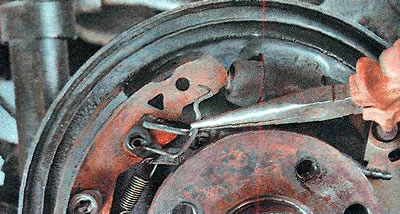 5. Remove the upper tension spring bracket.