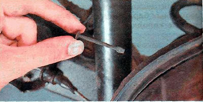 9. Remove the support stand and remove the front brake shoe.