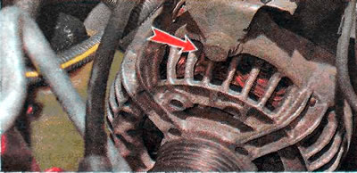 4. Using a 13 mm wrench, unscrew the bolt securing the wiring harness pad holder.
