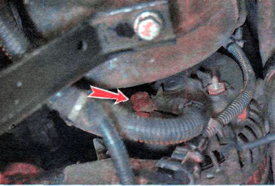 4. Using a 13 mm wrench, unscrew the nut...