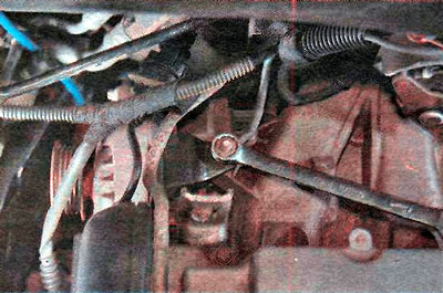 5. Using a 13 mm wrench, unscrew the nut...