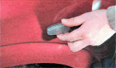 2. Move the side turn signal forward and remove it from the hole in the wing.