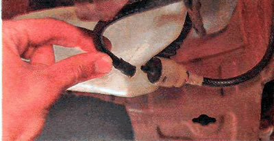 4. Disconnect the front windshield washer hose from the pump.