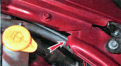 3. Remove the hood cable from the holder above the front left headlight.