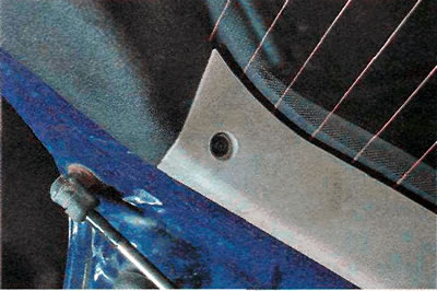 3. Using a TORX T25 key, unscrew the two bolts securing the left and right trim panels.