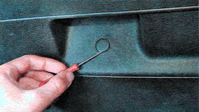 4. Using a thin slotted screwdriver, remove two plugs from the left and right sides of the luggage…