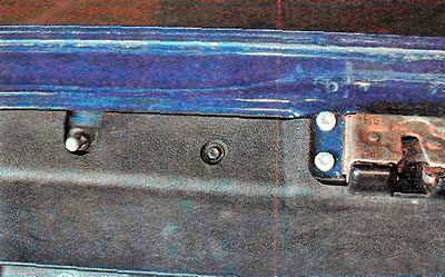 6. Using the same key, unscrew the two lower screws on both sides.