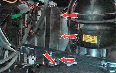 11. Using a slotted screwdriver, remove the four filter cover retaining clips.